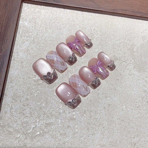 Pink Sunshine handmade press on nails with elegant designs and shimmering accents.